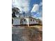 Home's exterior boasts a light gray vinyl finish, a gravel drive, and brick steps at 3437 Wilkesboro Hwy, Statesville, NC 28625