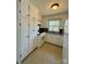 Clean kitchen with white cabinets, tile flooring, and modern appliances offers a functional design at 3437 Wilkesboro Hwy, Statesville, NC 28625