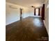 Living room showcasing hardwood floors, ceiling fan, windows, and entry doorway at 3437 Wilkesboro Hwy, Statesville, NC 28625
