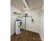 Compact utility room featuring water heater, shelving, and electrical panel on painted walls at 3437 Wilkesboro Hwy, Statesville, NC 28625