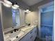 Bathroom featuring double sinks, granite counters, modern fixtures, and decorative lighting at 3537 Taxahaw Rd, Lancaster, SC 29720