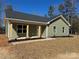 Charming single-story home with light green siding, stone accents, and a well-manicured lawn at 3537 Taxahaw Rd, Lancaster, SC 29720
