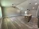 Spacious living room featuring luxury vinyl plank flooring, vaulted ceilings, and lots of light at 3537 Taxahaw Rd, Lancaster, SC 29720
