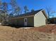 The backyard with a patio and freshly tilled space for landscaping at 3537 Taxahaw Rd, Lancaster, SC 29720