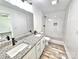 Bathroom featuring double granite vanity and tiled walk-in shower at 405 Aquadale Rd, Albemarle, NC 28001
