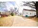 Long driveway leading to a white brick home, showcasing the ample parking space available at 405 Aquadale Rd, Albemarle, NC 28001