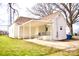 Back exterior of a brick home with a covered carport, stairs, and a small yard at 405 Aquadale Rd, Albemarle, NC 28001