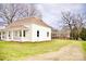 White brick home with a well-maintained lawn and an extended driveway leading to the back at 405 Aquadale Rd, Albemarle, NC 28001
