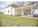 Side exterior of a brick home with a covered carport, stairs, and a small yard at 405 Aquadale Rd, Albemarle, NC 28001