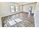 Bright living room with large windows and LVP flooring at 405 Aquadale Rd, Albemarle, NC 28001