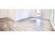 Bright living room with large windows and LVP flooring at 405 Aquadale Rd, Albemarle, NC 28001