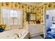 This bathroom features white floral wallpaper, large jacuzzi tub, white vanity and a view to the toilet at 423 Bethel Dr, Salisbury, NC 28144