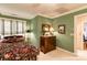 This bedroom features a bed with a floral spread, a wooden dresser, and soft green walls at 423 Bethel Dr, Salisbury, NC 28144