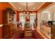 Formal dining room featuring bold, red walls, hardwood floors, and a decorative chandelier at 423 Bethel Dr, Salisbury, NC 28144