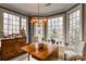 Inviting dining area with a chandelier and expansive windows provides a scenic setting for meals and gatherings at 423 Bethel Dr, Salisbury, NC 28144