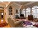 Bright living room featuring large arched windows, fireplace, built-in shelving, and decorative rug at 423 Bethel Dr, Salisbury, NC 28144