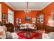 Elegant living room with rich, red walls, vintage furnishings, and natural light at 423 Bethel Dr, Salisbury, NC 28144
