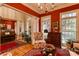 Bright living room with red walls, ample seating, and an open layout leading to other living areas at 423 Bethel Dr, Salisbury, NC 28144