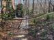 Backyard brick path leading through mature landscaping, offering a peaceful retreat at 511 Glencurry Dr, Charlotte, NC 28214