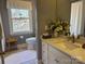 Bright bathroom with granite countertops, soft lighting, and decorative flowers at 511 Glencurry Dr, Charlotte, NC 28214