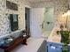Stylish bathroom featuring leaf wallpaper, tile shower, and marble countertops at 511 Glencurry Dr, Charlotte, NC 28214