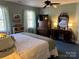 Comfortable bedroom with white comforter, wooden dresser, and ceiling fan at 511 Glencurry Dr, Charlotte, NC 28214