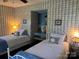 Cozy bedroom with blue plaid wallpaper features two twin beds, side tables, and a built-in desk at 511 Glencurry Dr, Charlotte, NC 28214