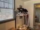 Coat rack with hats and coats, laundry basket, and window with blinds at 511 Glencurry Dr, Charlotte, NC 28214