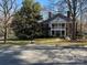 Charming brick home with a covered front porch and mature trees at 511 Glencurry Dr, Charlotte, NC 28214