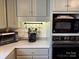 Kitchenette area featuring a microwave, oven, cabinets and mug rack at 511 Glencurry Dr, Charlotte, NC 28214