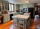 Spacious kitchen featuring an island with seating, a black refrigerator, and views of the backyard at 511 Glencurry Dr, Charlotte, NC 28214