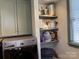 Laundry area has gray cabinets, open shelves, and modern washer and dryer at 511 Glencurry Dr, Charlotte, NC 28214