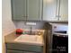 Laundry room features shaker cabinets, white tiled backsplash, and modern washer and dryer at 511 Glencurry Dr, Charlotte, NC 28214