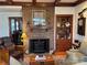 Living room with brick fireplace, hardwood floors, and an adjacent doorway at 511 Glencurry Dr, Charlotte, NC 28214