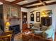 Comfortable living room with a brick fireplace, hardwood floors, and wood beams at 511 Glencurry Dr, Charlotte, NC 28214