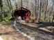 A red outbuilding with a brick walkway and chair at 511 Glencurry Dr, Charlotte, NC 28214