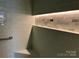 Updated tile shower with built-in shelf and handrail at 511 Glencurry Dr, Charlotte, NC 28214