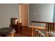 Upstairs landing has wood floor, blue walls and a door to another room at 511 Glencurry Dr, Charlotte, NC 28214