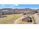 Aerial view of a brick home with expansive lawn, complemented by picturesque mountain views at 6231 Nc 16 N Hwy, Taylorsville, NC 28681
