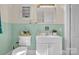 Vintage bathroom featuring ceramic teal tile, a toilet, and a sleek vanity cabinet at 6231 Nc 16 N Hwy, Taylorsville, NC 28681