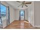 Bright, airy bedroom with hardwood floors, a ceiling fan, and a window showcasing outdoor views at 6231 Nc 16 N Hwy, Taylorsville, NC 28681