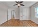 Bedroom with hardwood floors, white painted wainscoting, ceiling fan and closet at 6231 Nc 16 N Hwy, Taylorsville, NC 28681