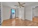 Bedroom featuring hardwood floors, a window, and a ceiling fan at 6231 Nc 16 N Hwy, Taylorsville, NC 28681