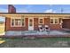 Charming brick home with covered front porch and seating area at 6231 Nc 16 N Hwy, Taylorsville, NC 28681
