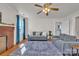 Comfortable living room with a brick fireplace, ceiling fan, and plush gray sofas on an area rug at 6231 Nc 16 N Hwy, Taylorsville, NC 28681