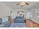 Open-concept living room featuring wood floors, a ceiling fan, and an adjoining kitchen area at 6231 Nc 16 N Hwy, Taylorsville, NC 28681