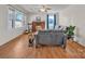 Cozy living room featuring a brick fireplace, hardwood floors, and abundant natural light at 6231 Nc 16 N Hwy, Taylorsville, NC 28681