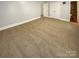 Empty bedroom showcasing neutral carpeting and ample closet space at 6606 Antrim Ct, Charlotte, NC 28217