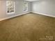 Bright bedroom with carpet and two windows providing natural light at 6606 Antrim Ct, Charlotte, NC 28217