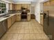 Bright kitchen featuring stainless steel appliances, tile flooring, and ample counter space at 6606 Antrim Ct, Charlotte, NC 28217